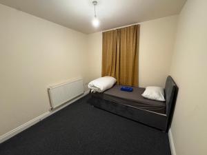 a small room with a bed and a window at Barnsley Guesthouse in Barnsley