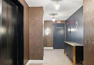 a hallway with a blue door and a number on the wall at Stunning 1bd1bth I New Construction in Wilmington