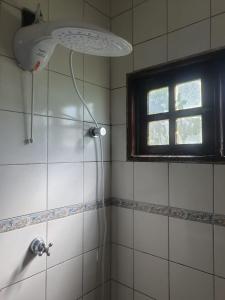 a shower in a bathroom with a window at Nessa Familia P Frances in Marechal Deodoro