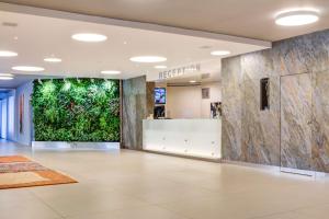 an empty lobby with a large green wall at Best Western Hotel Vista in Ostrava