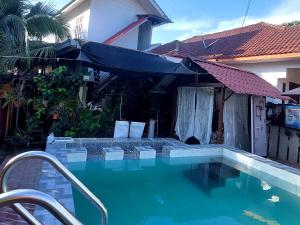 a swimming pool in front of a house at Cassa Bonda Standard Double Room in Macang