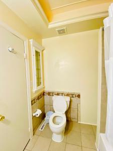 a bathroom with a toilet and a window at 1 bedroom terrace view with shared bathroom #4 in Laurel +12 photos