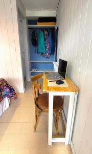 a desk with a laptop computer on top of it at Lago Argentino Hostel in El Calafate