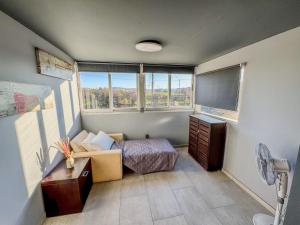 a small room with a bed and a television at Beachlife: The Bungalow in Kos