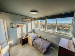 a small bedroom with a bed and two windows at Beachlife: The Bungalow in Kos +11 photos