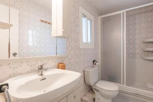 a white bathroom with a sink and a toilet at Feel Welcome Barcelona 10 in Cornellà de Llobregat +22 photos