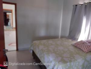 a bedroom with a bed with a curtain and a window at Rancho Bela Vista - Corumbá IV in Alexânia +8 photos