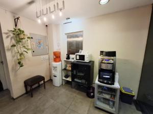 a room with a kitchen with a microwave and appliances at Edificio Recoleta - Hoteles Recoleta in Buenos Aires