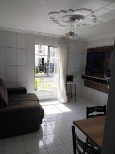 a living room with a couch and a window at Cop 30 - Ananindeua Apartamento in Ananindeua