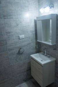a bathroom with a sink and a mirror at Bahia Urban Apartments in Bahía Blanca