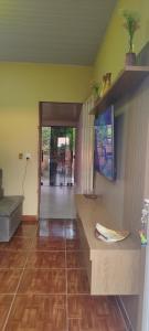 a living room with yellow walls and a wooden floor at Espaço Moura in Chapada dos Guimarães +25 photos