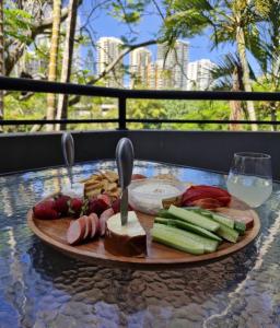 a plate of food on a table with cheese and vegetables at Serenity in Surfers Paradise in Gold Coast