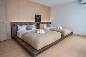two large beds in a room with wooden floors at Apartment Hotel 11 Villa Tengachaya in Osaka