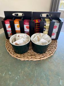 a basket with two baskets of food on a table at The Park Cottage in Napier +8 photos