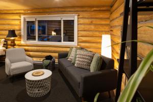 a living room with a couch and a window at River's Edge Glamping in Clearwater