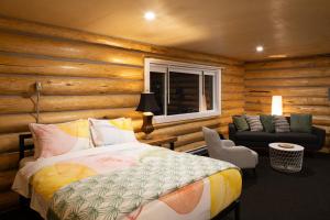 a bedroom with a bed and a chair and a window at River's Edge Glamping in Clearwater +25 photos
