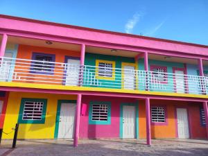 a brightly colored building with a balcony at Hotel Destino EISA in Cuatrociénegas de Carranza
