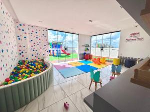 a play room with a rock wall and a playground at Quelônia Residence in Nossa Senhora do Livramento