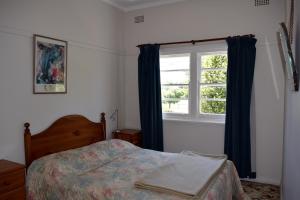 a bedroom with a bed and a window at Clanwilliam in Blackheath