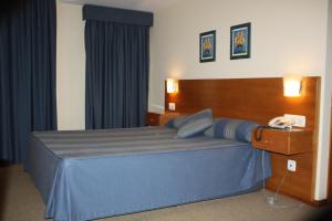 Cama ou camas em um quarto em Hotel das Taipas