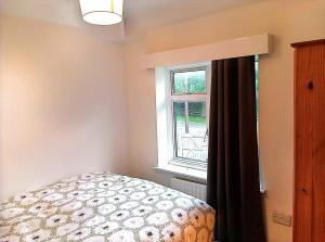 a bedroom with a bed next to a window at YPCC Rhodesway in Bradford +4 photos