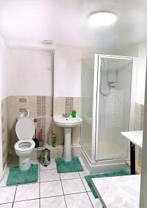 a bathroom with a shower and a toilet and a sink at YPCC Rhodesway in Bradford