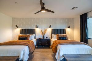 a bedroom with two beds and a ceiling fan at Villas 1, 2, 3 The Villas At Troon North in Scottsdale +55 photos