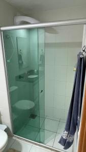 a glass shower in a bathroom with a toilet at Taguá Life Resort - Ideal para sua estadia in Riacho Fundo