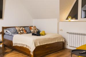 a bedroom with a bed with pillows on it at Apartament pod Gubają in Zakopane