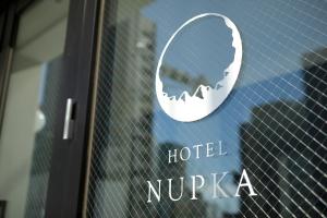 a hotel nucaya sign on the door of a building at Hotel Nupka in Obihiro