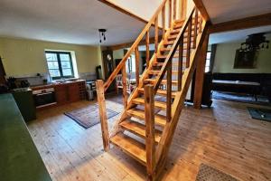 a wooden staircase in a room with a kitchen at Ferienhaus in Wendorf am Seenland in Wendorf