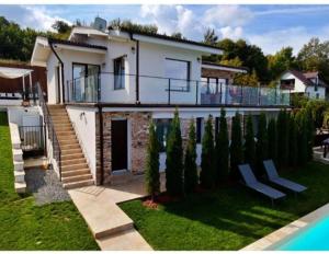 a house with a swimming pool in front of it at Panoramic Palace in Feleacu