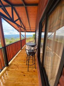 a view from the balcony of a cabin with a table at Cabaña Con Hermosa vista y ambiente de campo in Miravalles