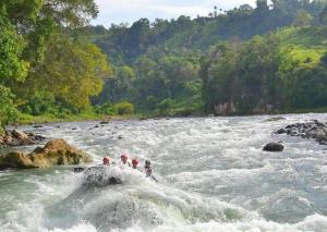 a group of people on a raft in a river at Hotel Juliana by RedDoorz in Tuguegarao City