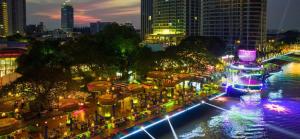 a city street at night with lights and buildings at Apartment Condo Rent Near River in Phnom Penh City in Phnom Penh