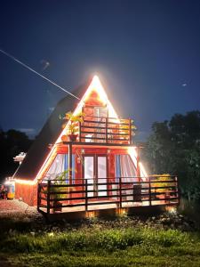 a house with lights on the side of it at Cabaña 787 in Lares