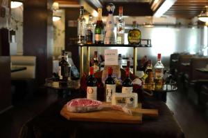 a table with bottles of wine and meat on it at Wyndham Garden Los Mochis Plaza Inn in Los Mochis