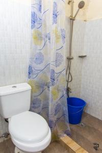 a bathroom with a toilet and a shower curtain at Affordable MODERN Up to 16 Pax Near Aqua Planet & Clark International Airport in Angeles +50 photos