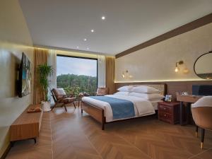 a hotel room with a bed and a large window at Pandora Boutique Hotel---Within Zhangjiajie National Forest Park in Zhangjiajie