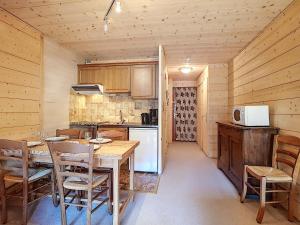 a kitchen with a table and chairs in a cabin at La Clusaz: Duplex 4 pers, Animaux admis, Parking réservé - FR-1-818-90 in La Clusaz