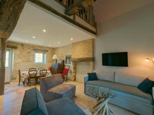 a living room with a couch and a dining room at Gîte charmant avec parking, animaux acceptés, près du Château de Clavières - FR-1-591-718 in Ardentes