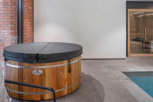 a large wooden barrel sitting next to a building at Perfectly Paired - Your Dual Apartment Escape in Wellington