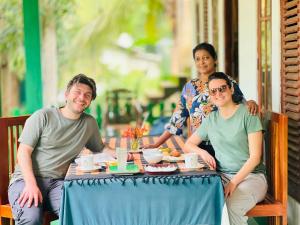 a group of people sitting at a table at Jm Resort in Dambulla