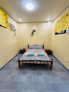 a bedroom with a bed and a bike on the wall at BELLAVISTA de boracay GUEST HOUSE in Boracay