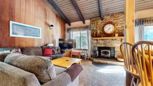 a living room with a couch and a fireplace at Discover 4 in Mammoth Lakes