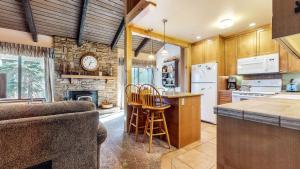 a kitchen with a table and chairs and a clock at Discover 4 in Mammoth Lakes
