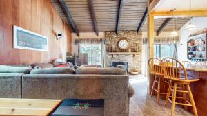 a living room with a couch and a table at Discover 4 in Mammoth Lakes