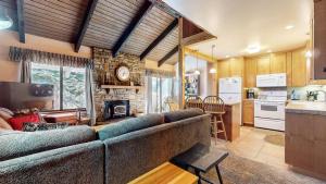 a living room with a couch and a kitchen at Discover 4 in Mammoth Lakes