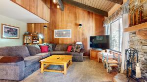 a living room with a couch and a table at Discover 4 in Mammoth Lakes +35 photos