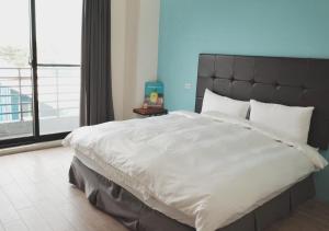 Ένα ή περισσότερα κρεβάτια σε δωμάτιο στο Happy Guesthouse